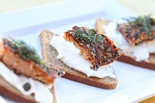 Delicious seasoned smoked salmon with dill and capers served on rye. 
