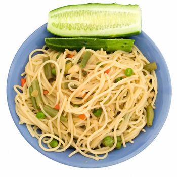 Spaghetti and green cucumber in a blue plate on a white background