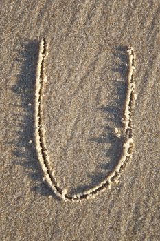 Text written on wet sand