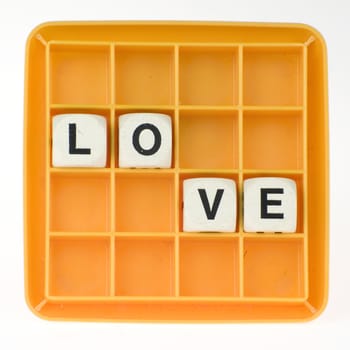 a lot of old dices with letters spell out "love"