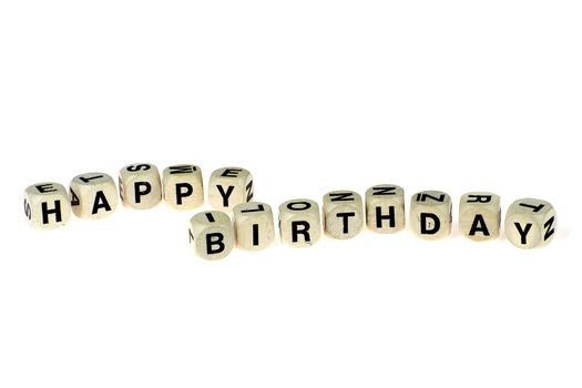 a lot of old dices with letters, spell out "happy birthday"