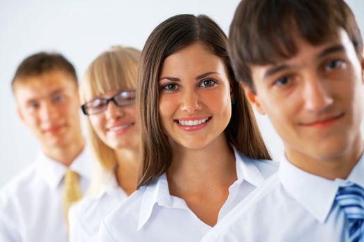  Happy business woman with her colleagues standing in a row.
