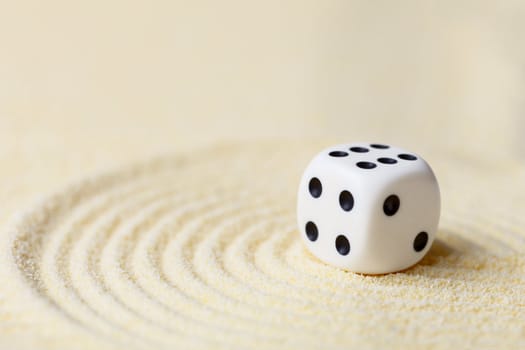 Art composition from playing dice on a sand surface