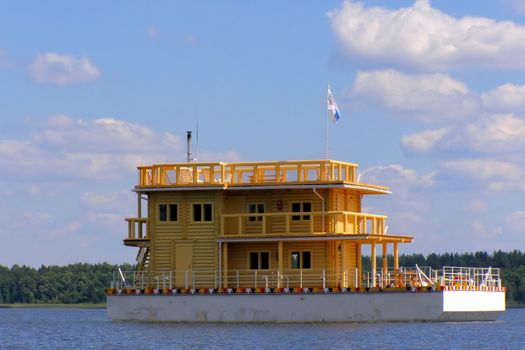 house from beam on the water against cloudy sky