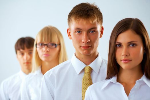 Portrait of young  business man with his colleagues standing in a row