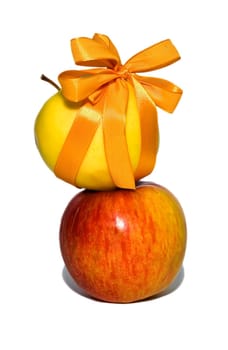 couple of red and yellow apples with a gift bow on a white background