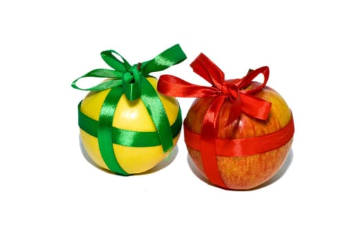 couple of red and yellow apples with a gift bows on a white background