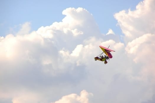 hang-glider on the cloudy sky looks like sky bicycle
      