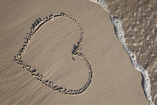 Heart painted on wet sand