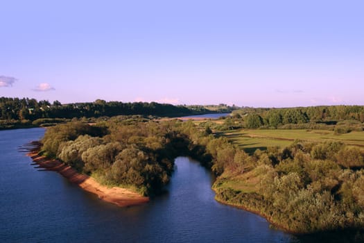 Island part on the river under the azure sky with rare clouds