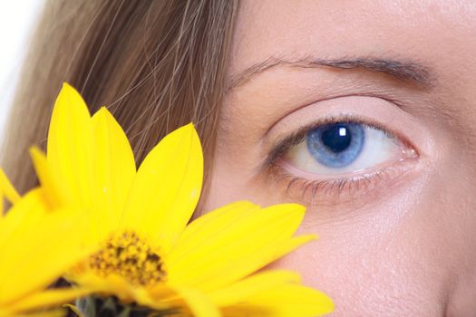 Female eye with a yellow flower removed close up