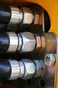 The chromeplated nuts of hydraulic system of a dredge detailed, (look similar images in my portfolio)