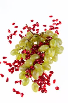 Cluster of grapes and pomegranate grain removed close up