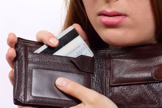 The girl with a purse and a bank card removed close up