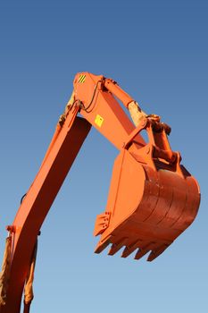 Hand and shovel bucket on a background of the blue sky, Isolated (look similar images in my portfolio)