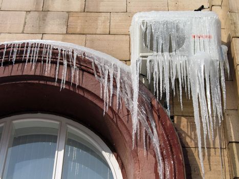 Icicles on the conditioner in frosty day in Volgograd