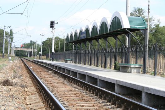 Railway station, rails, columns, wires and a traffic light, (look similar images in my portfolio)
