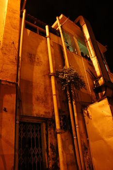 Night shot of the back of shop house at the alley