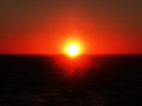 The sun setting over the ocean.