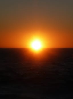 The sun setting over the ocean.