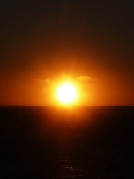 The sun setting over the ocean.