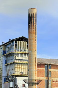 Detail of factory with tall chimney