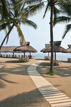 Relaxing shady beach Palapas and path