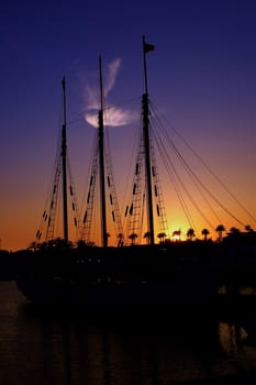 Cloud that looks like an angel over looking a sail boat in Long Beach Harbour at sunset.