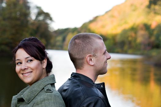 A young happy couple outdoors on a fall day.