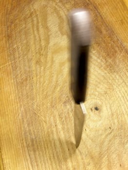Swayed kitchen knife in the cutting board