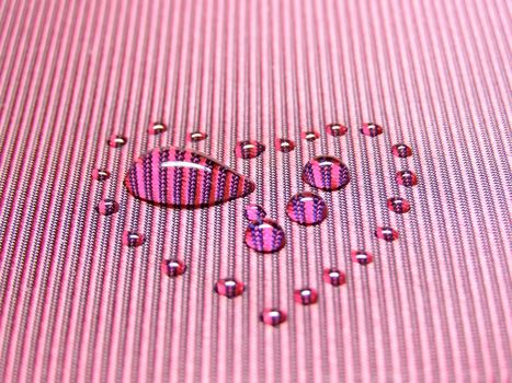 water drop among other drops in heart form