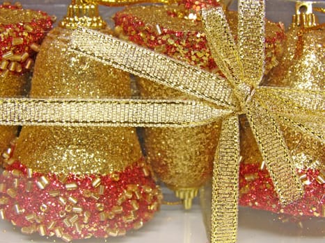 christmas decorated golden bells with tie in a bow