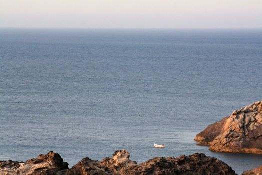 a little boat and the fisherman at the sea
