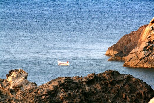 a little boat and the fisherman at the sea
