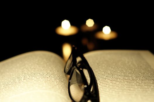 book candle and glasses with black copyspace