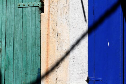 blue and green colored doors from a little mediterranean  town
