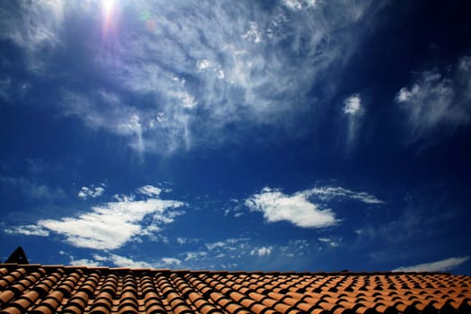 bright and clean image of a roof and a cloudy sky
