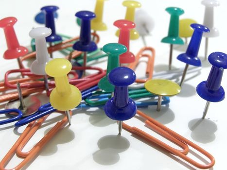 multicolored thumb tacks and paper clips  