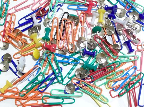 multicolored thumb tacks and paper clips  