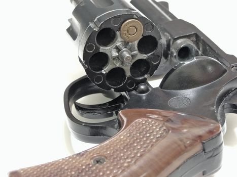 open cylinder of revolver with one bullet inside