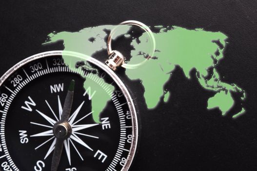 world map and compass showing business guidance concept