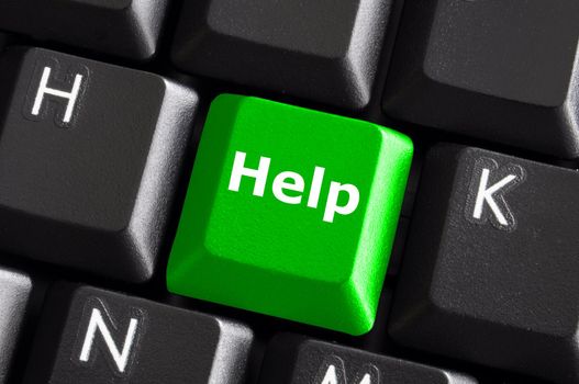 help support or assistance concept with green button on computer keyboard