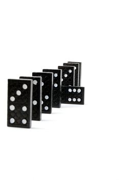 row of dominoes including a special domino stone isolated on white background