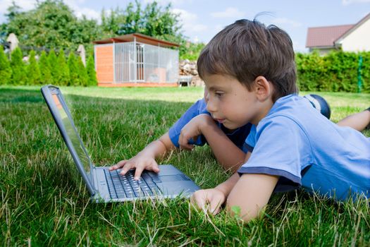 Two cute boy study on computer 