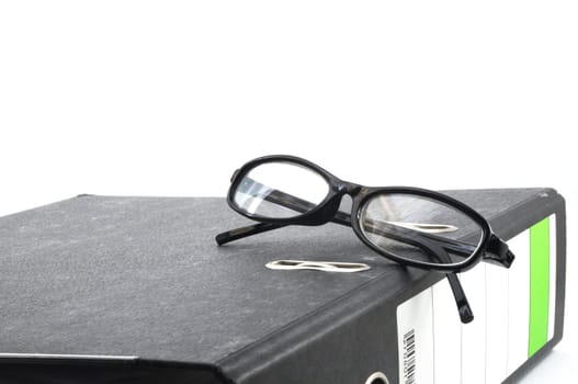 eye glasses and folder in the office showing paperwork concept