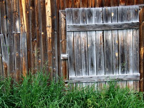 Old wooden door - entrance to a barn.