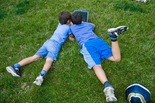 Two cute boy study on computer 