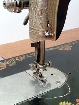 Old metal sewing machine over white background   