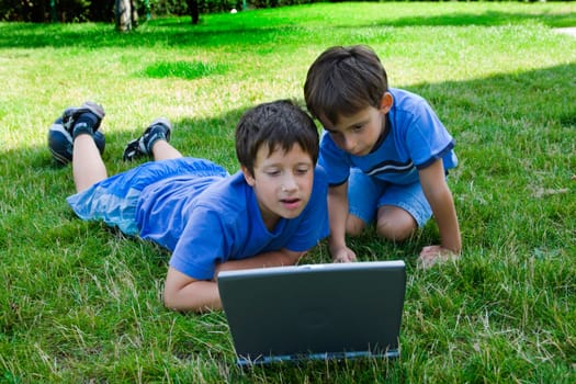 Two cute boy study on computer 