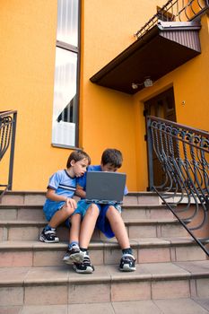Two cute boy study on computer 